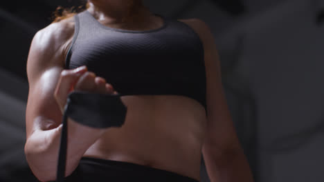 Close-Up-Studio-Shot-Of-Mature-Woman-Wearing-Gym-Fitness-Clothing-Exercising-With-Resistance-Band-3